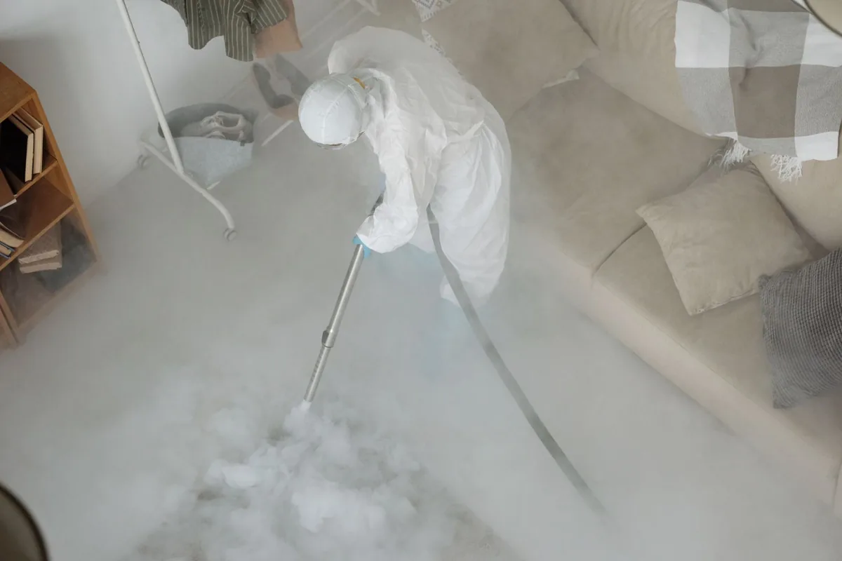 Biohazard cleanup technician in protective equipment, Platteville, CO